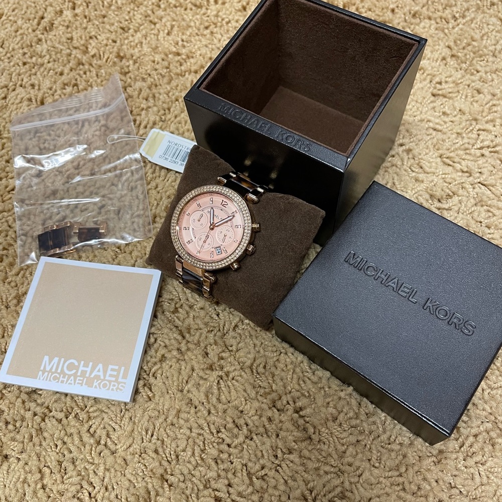 Michael Kors watch rose gold face, with tortoise shell strap.